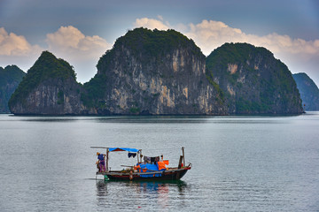 Naklejka na ściany i meble Ha Long Bay , Vietnam-29 November 2014:Fishing boat in Ha long Bay, Panoramic view of sunset in Halong Bay, Vietnam, Southeast Asia,UNESCO World Heritage Site