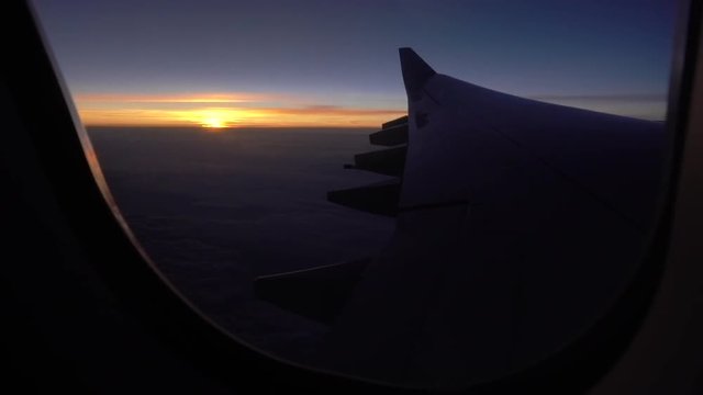 POV shot, airplane window of sunset