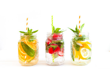 Homemade iced lemonade with mint, summer fruits and berries in a mason jar. Copy space background