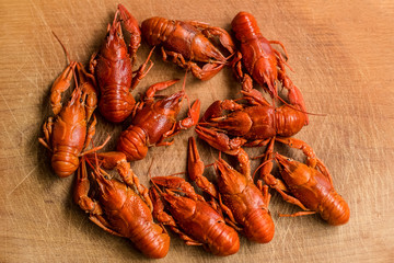 boiled crayfish food and drinks concept on wooden cutting board desk with empty space for copy or text