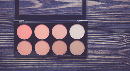 Top view a collection of cosmetic makeup on wooden table background, products cosmetic fashion concept, vintage retro style.