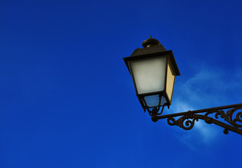 Fototapeta na wymiar Old fashioned street lamp against blue sky (with copy space)