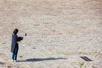 Female tourist taking a Selfie at Montjuic Castle parade ground in Barcelona Spain