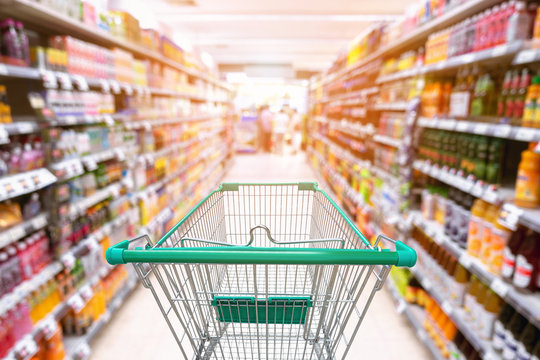 Abstract Defocused Blurred of Consumer Goods and Shopping Cart in Supermarket Store, Shop Trolley Basket in Department Store. Business Retail Customer Shopping Mall Service, Convenience Supermarkets