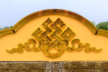 Golden endless knot sign on buddhist temple