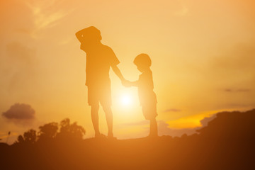 silhouette of a happy children and happy time sunset