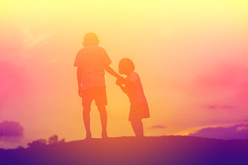 Fototapeta premium silhouette of a happy children and happy time sunset