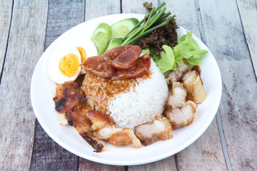 Jasmine rice with meat and boiled egg topped red sweet sauce .