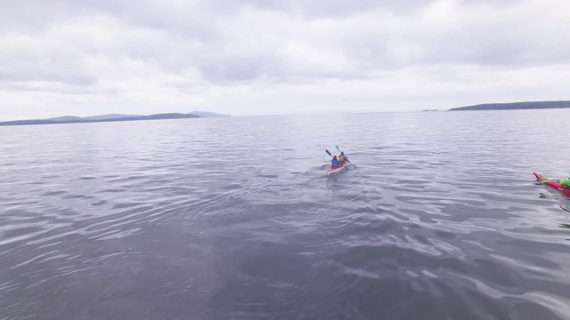 Wide, people kayak in San Juan Islands