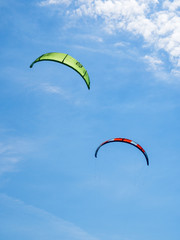 Kite surf sails in the blue sky.