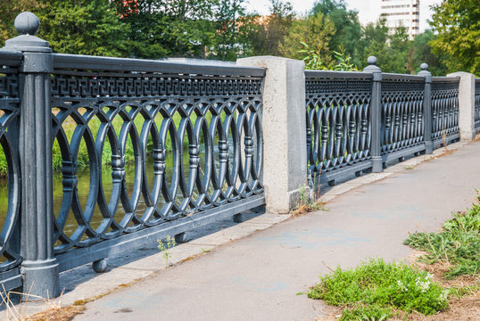 Cast iron parapet on the embankment of the river Yauza in the Rostokino district. Moscow, Russia