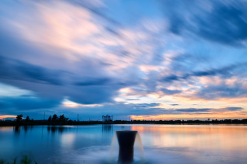 The oil pumping units  and cloudscape sunset.