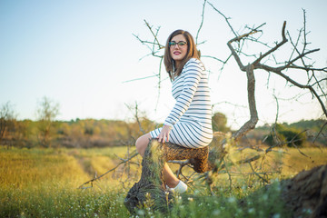 Enjoying the nature. Young beautiful girl enjoying the fresh air in green meadow. sunny sumer/spring day.