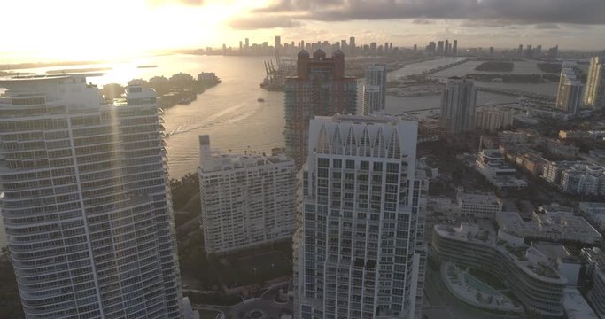 Sunset over skyscrapers in Miami, tilt up aerial