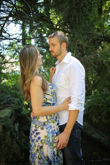 Romantic Couple Side view portrait of a Young Caucasian Couple in an Embrace with Natural Lighting Outside on a Spring or Summer Day