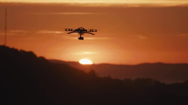 Panning shot drone octocopter filming cinematic sunset with DSLR