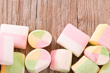 Marshmallows on wooden table.