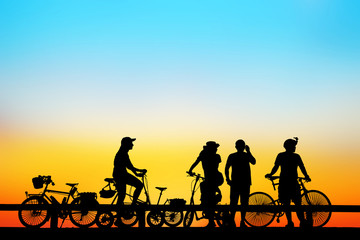 Fototapeta na wymiar Silhouette group bike relaxing on blurry sunrise background