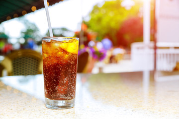 a glass containing an alcoholic drink on a table of a terrace of a bar