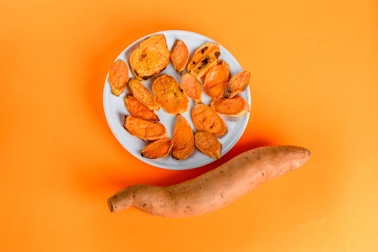 Top View White Dish Of Sliced And Raw Sweet Potatoes.Healthy And Energy, Athletic Food, Thanksgiving, Christmas Or Other. Roasted Sweet Potatoes On The Grill Pan On The Plate Close-up. Shot From Above