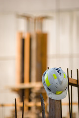 Hard hat on a construction site with wooden form-work in the background
