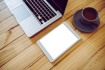 Tablet mock-up, laptop, with coffee cup on wooden table