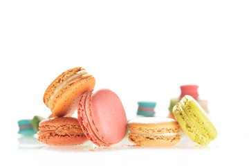 Colorful french macarons on white background.
