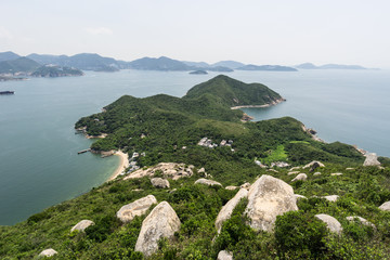 Fototapeta premium Wspaniały widok na nierówne wybrzeże wyspy Lamma z wyspą Hongkong w tle w Hongkongu, SAR Chiny