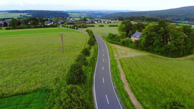 Aerial drone flight over a street in the nature