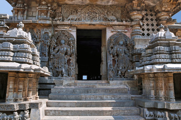 Dwarapala on the right, Ganesha and other sulptures, South entrance of Shantaleswara shrine, Hoysaleshvara Temple, Halebid, Karnataka