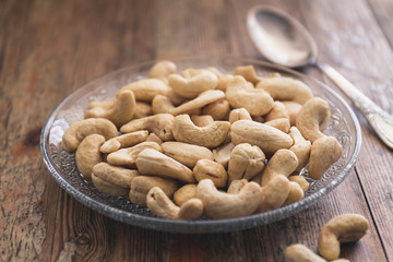 Cashew nuts on a vintage or rustic wood table top background