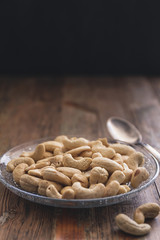 Cashew nuts on a vintage or rustic wood table top background