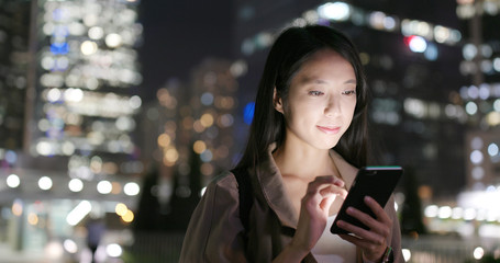 Woman use of mobile phone at night