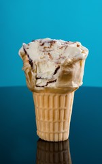ice cream cone on a blue background with some bites