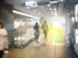 Abstract background of blurred image of people in shopping mall with bokeh. Vintage tone. for background usage