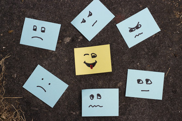 Unhappy smilies and a happy face painted on office stickers