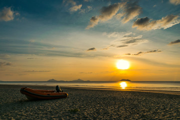 boat at sunrise on bang baen beach in Ranong