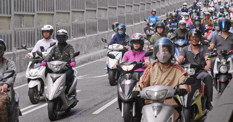 Taiwanese people ride motorcycles on the ramp of Taipei Bridge