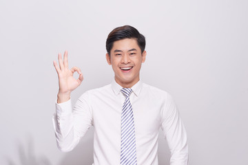 Portrait of a handsome man doing a success symbol