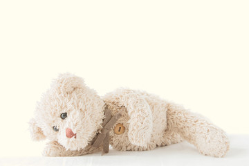 Fototapeta premium Cute little teddy bear lay down on the bed 