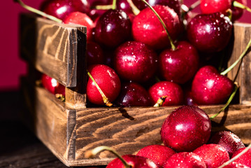 Fresh sweet cherries in a wooden box close