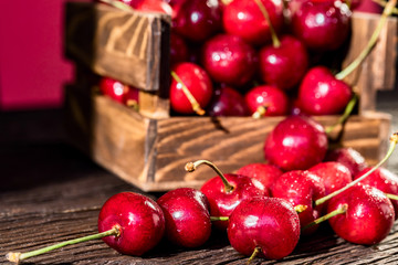 Fresh sweet cherries in a wooden box close