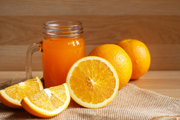 Orange and orange juice on wooden background