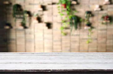 Selected focus empty brown wooden table and Coffee shop or restaurant blur background with bokeh image. for your photomontage or product display
