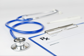 Close up stethoscope with prescription on white background.