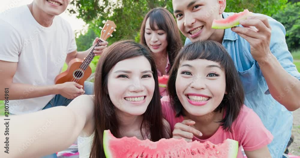 Poster people enjoy at a picnic