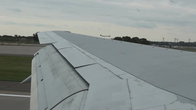 Slow motion clip of landing at Minneapolis-Saint Paul International Airport alongside a 2nd airplane