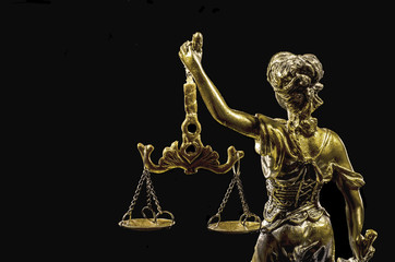 Statue of Justice on the black background, back view