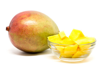 Mango fruits and mango cubes in the glass bowl. Diced mango