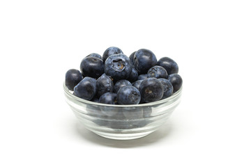 Bilberry in the transparent bowl on the center of the white background